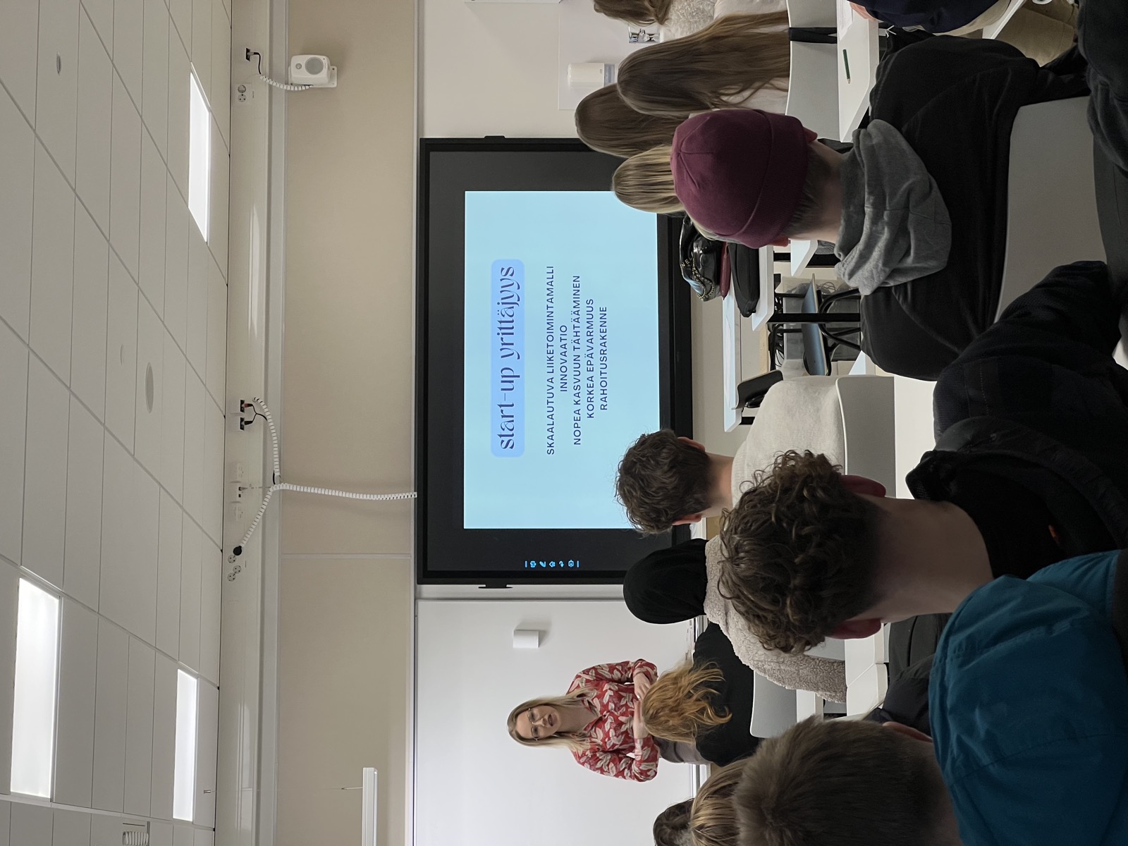 Entrepreneur Jenni Ikonen speaking to a classroom of upper secondary students at Viherlaakson lukio.
